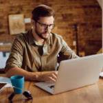 male-entrepreneur-working-computer-home_637285-12152